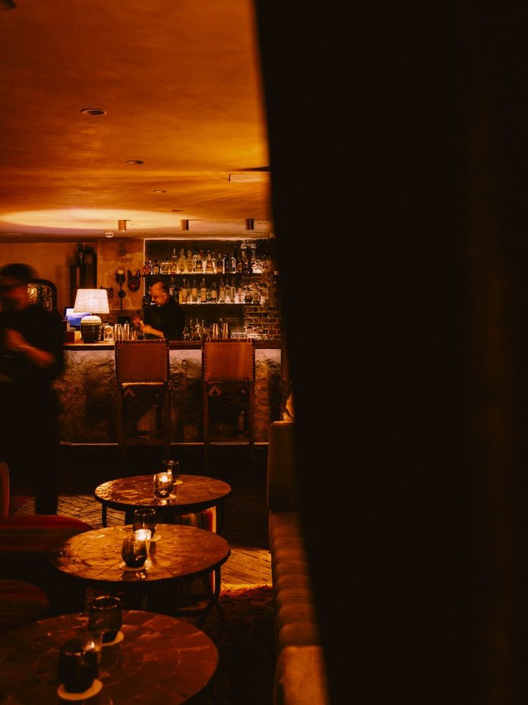 The bar and low tables, seen across the room.